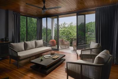 Spacious villa living area at The Namkhan in Luang Prabang featuring contemporary furnishings, warm wood finishes, and floor-to-ceiling windows opening to pr...