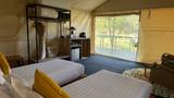 Twin bed tent accommodation with private terrace overlooking the Nam Khan River at The Namkhan resort in Luang Prabang, Laos