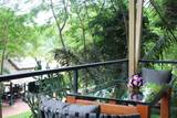 Private terrace with dining table overlooking tropical forest canopy at The Namkhan eco-resort in Luang Prabang, Laos