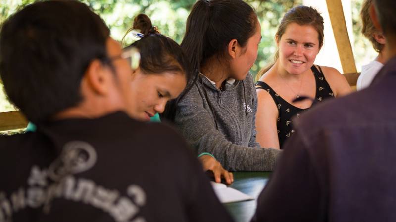 Group of participants engaged in a collaborative workshop activity at The Namkhan resort in Luang Prabang, Laos